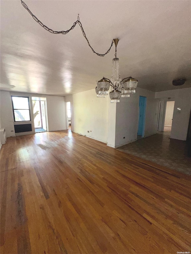 interior space featuring a chandelier and wood-type flooring