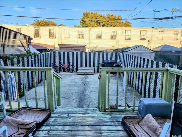 wooden deck featuring a grill