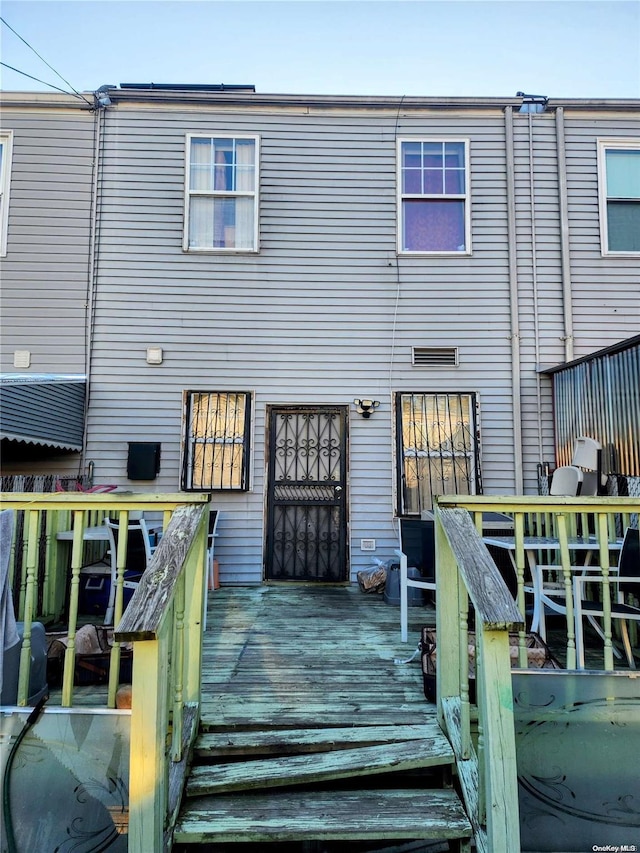 rear view of property featuring a deck