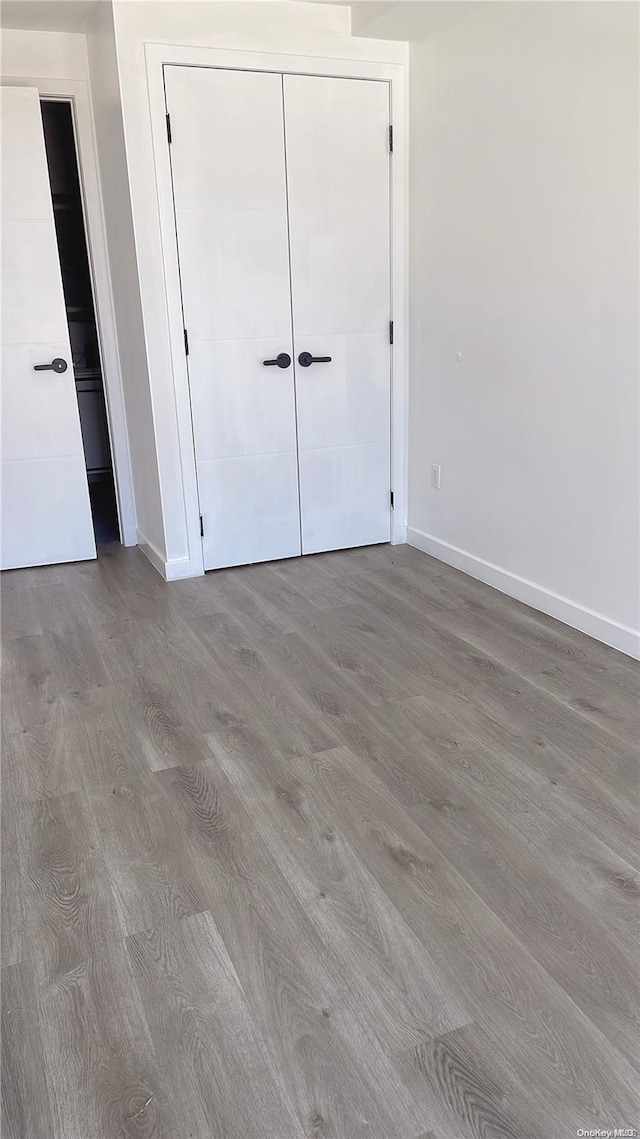 unfurnished bedroom featuring a closet and light wood-type flooring