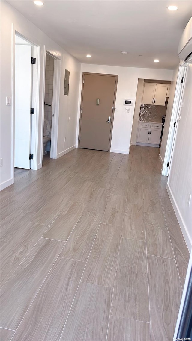 interior space featuring a wall mounted air conditioner and electric panel