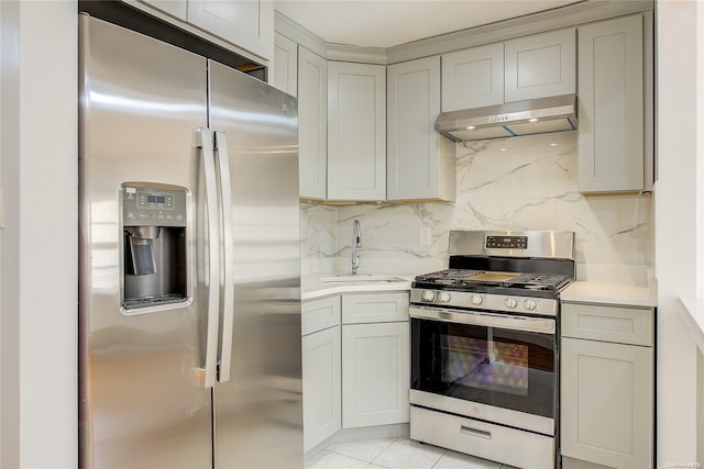 kitchen featuring tasteful backsplash, gray cabinetry, stainless steel appliances, sink, and light tile patterned floors