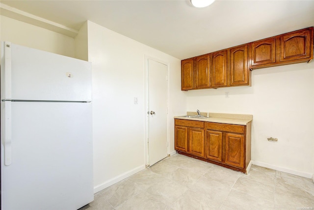 kitchen with white refrigerator and sink