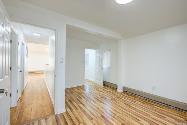 hallway featuring light hardwood / wood-style floors and a baseboard radiator