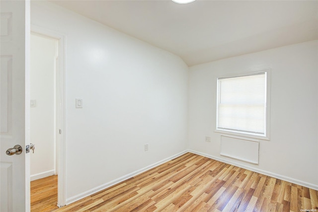 empty room with light hardwood / wood-style flooring