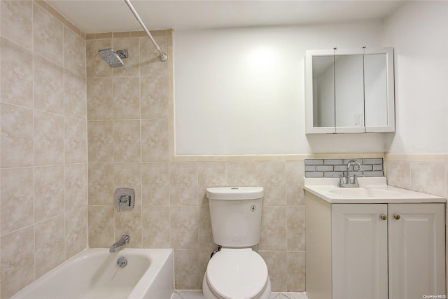 full bathroom with vanity, tiled shower / bath combo, tile walls, and toilet