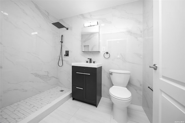 bathroom featuring tiled shower, vanity, toilet, and tile walls