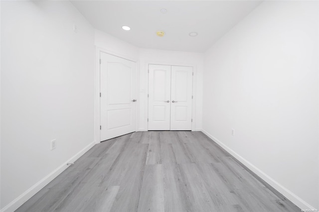 unfurnished bedroom featuring a closet and light hardwood / wood-style floors