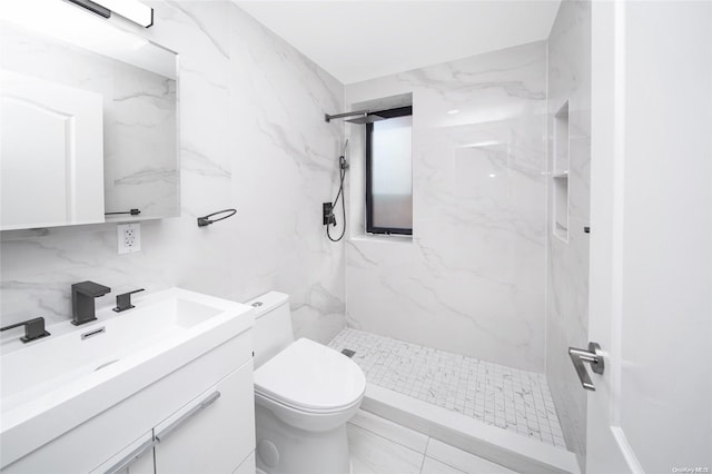 bathroom featuring vanity, decorative backsplash, toilet, tile walls, and a tile shower