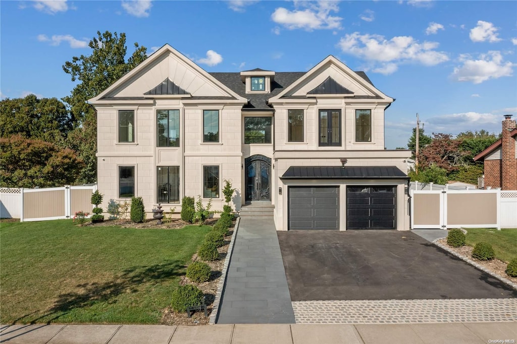 view of front of house featuring a front yard and a garage