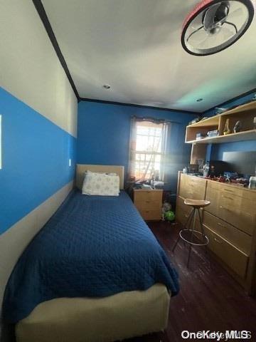 bedroom with dark wood finished floors