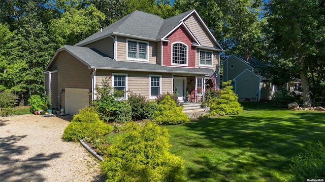 view of front facade featuring a front yard and a garage