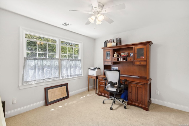 carpeted office with ceiling fan