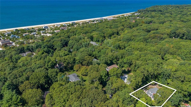 birds eye view of property with a water view and a view of the beach