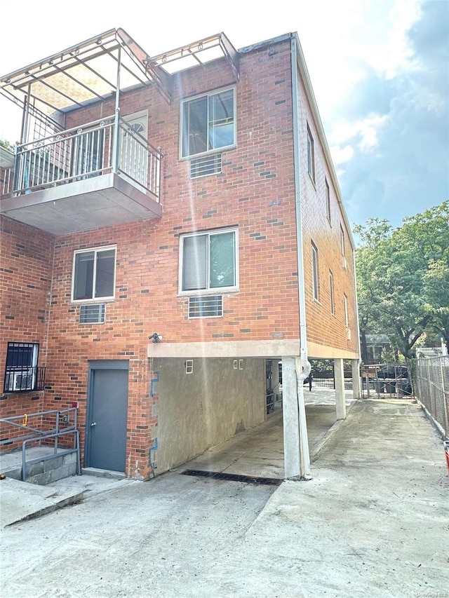 view of home's exterior with a balcony