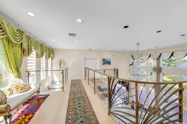 corridor with light hardwood / wood-style floors