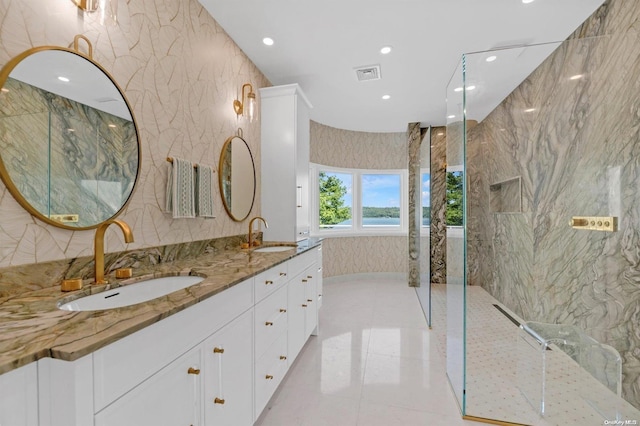 bathroom with vanity and tiled shower