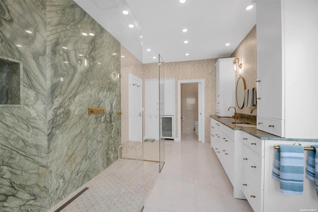 bathroom with vanity, toilet, and tile walls