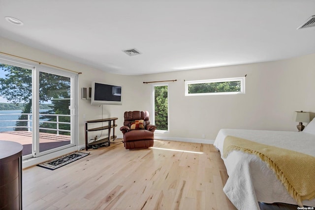 bedroom featuring light hardwood / wood-style floors and access to outside