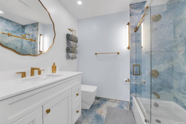 bathroom with vanity, toilet, and an enclosed shower