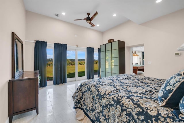 bedroom with access to exterior, ceiling fan, and a towering ceiling