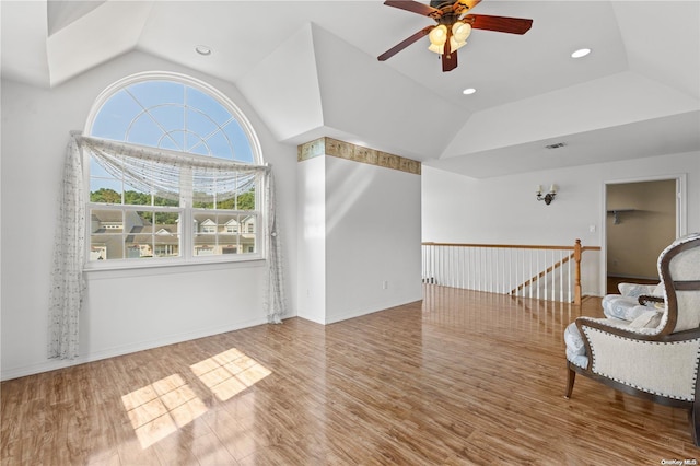 interior space with hardwood / wood-style flooring, ceiling fan, and vaulted ceiling