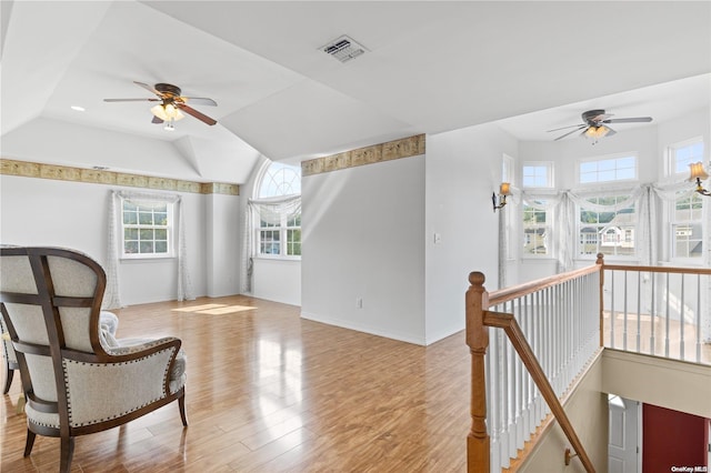 sitting room featuring ceiling fan, lofted ceiling, and light hardwood / wood-style flooring