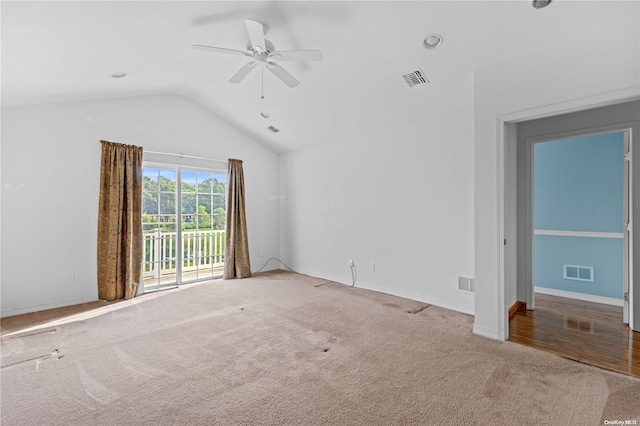 empty room with hardwood / wood-style flooring, ceiling fan, and lofted ceiling