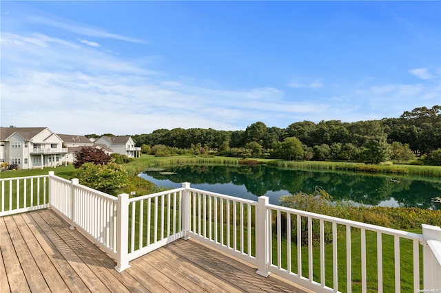 wooden deck featuring a yard and a water view