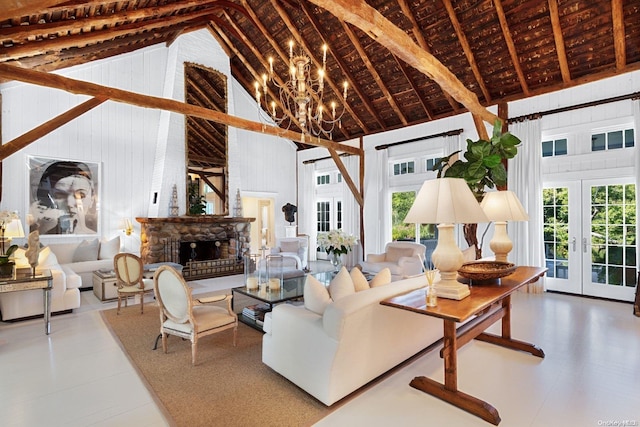 living room with a fireplace, french doors, high vaulted ceiling, and a healthy amount of sunlight