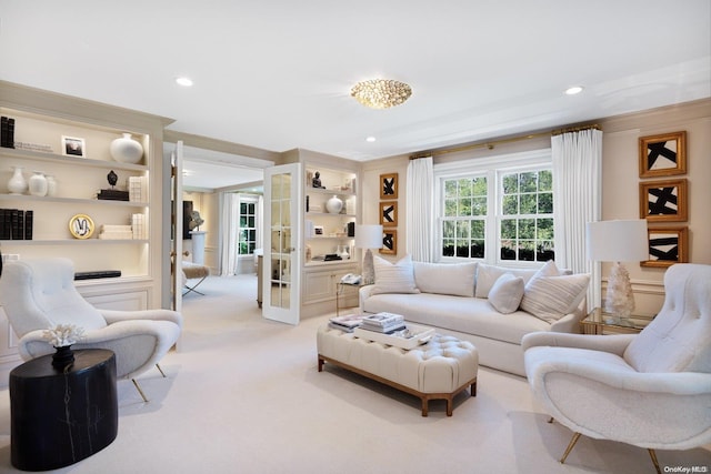 carpeted living room with ornamental molding