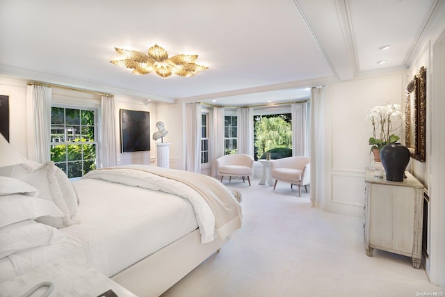 carpeted bedroom featuring an inviting chandelier, crown molding, and multiple windows