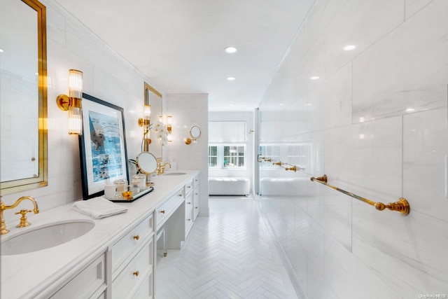 bathroom featuring vanity, ornamental molding, and tile walls