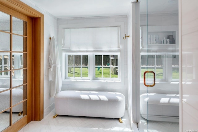 interior space with crown molding, parquet floors, and a healthy amount of sunlight