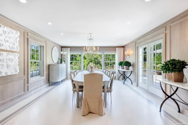 dining space with crown molding and french doors