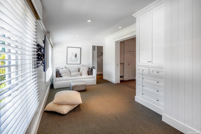 sitting room featuring crown molding, dark carpet, and vaulted ceiling