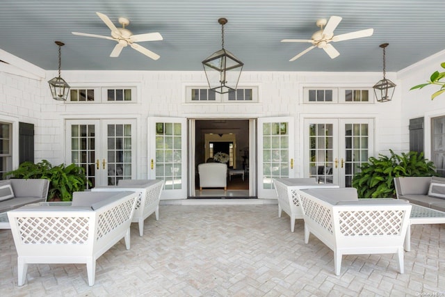 sunroom / solarium featuring ceiling fan and french doors