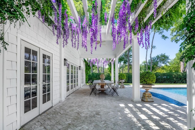 view of patio featuring a fenced in pool and french doors