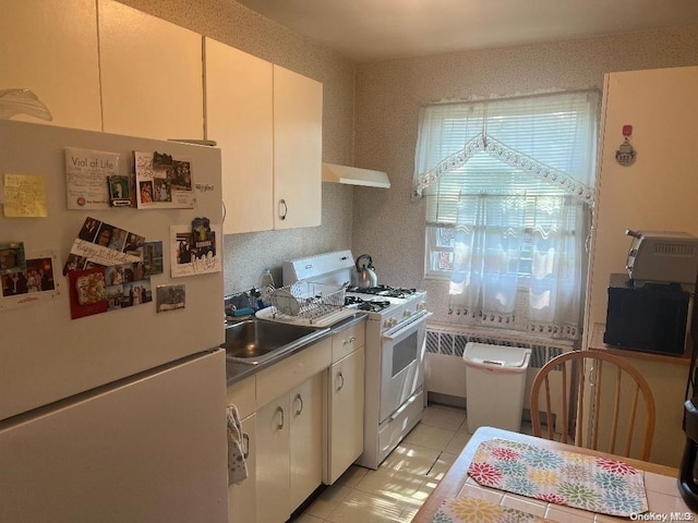 kitchen with sink, light tile patterned floors, white appliances, and ventilation hood