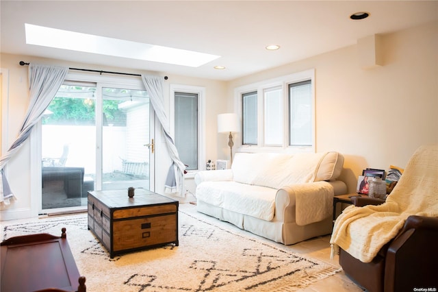 tiled bedroom featuring access to exterior and a skylight