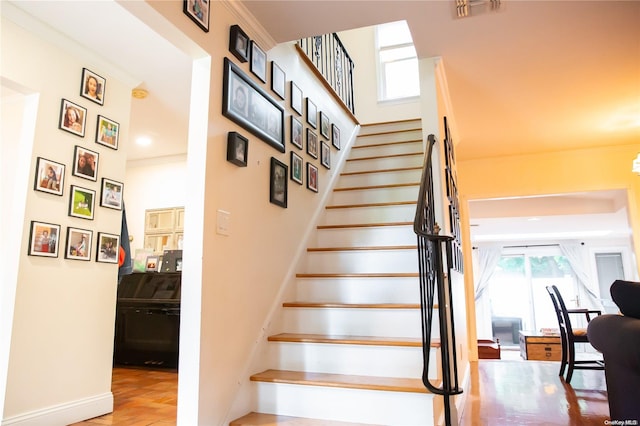 stairway featuring crown molding