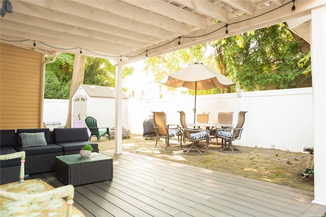 deck with an outdoor hangout area and a storage shed