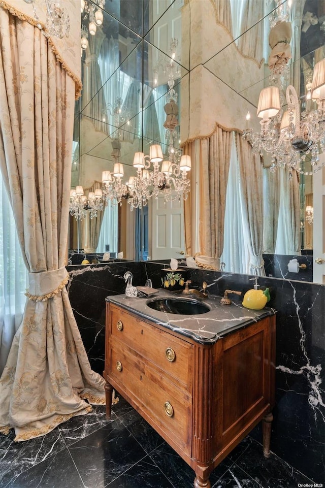 bathroom featuring vanity, tile walls, and an inviting chandelier