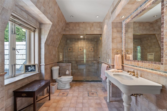 bathroom featuring french doors, toilet, and tile walls