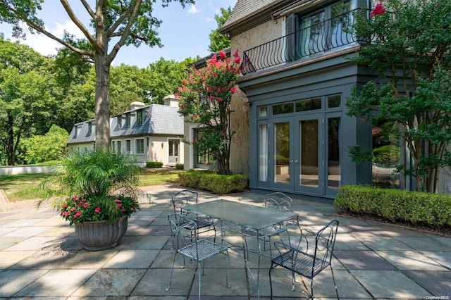 view of patio featuring french doors and a balcony