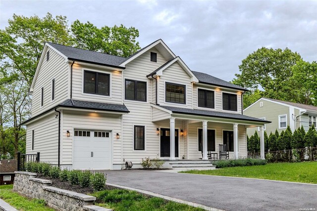 view of front of home featuring covered porch and a garage