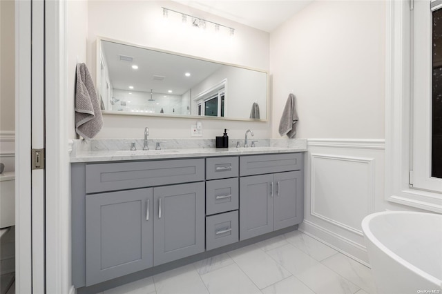 bathroom featuring a bathing tub and vanity