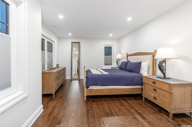 bedroom with dark wood-type flooring