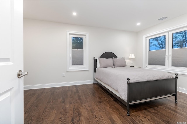 bedroom with dark hardwood / wood-style flooring