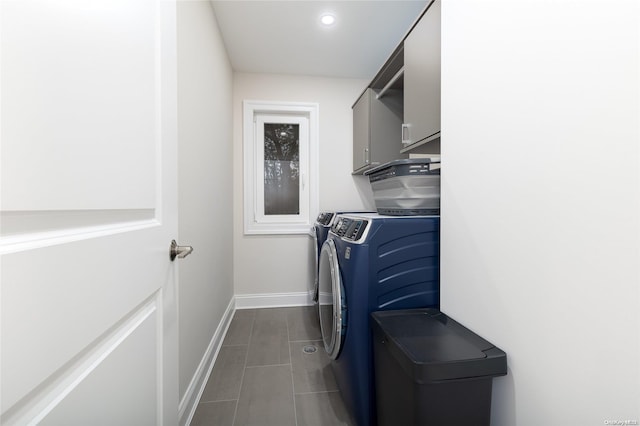 laundry room featuring washer and clothes dryer and cabinets